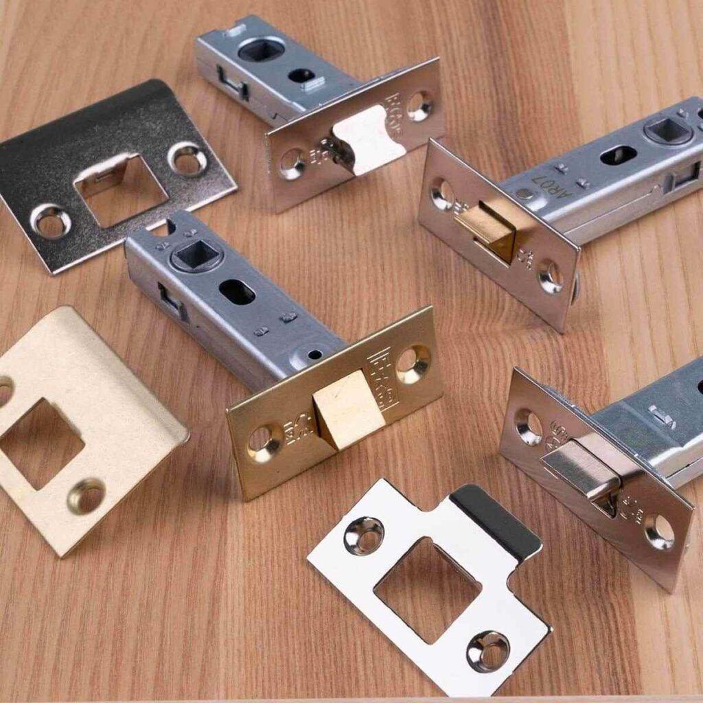 A collection of Eurospec tubular latches on a wooden background.