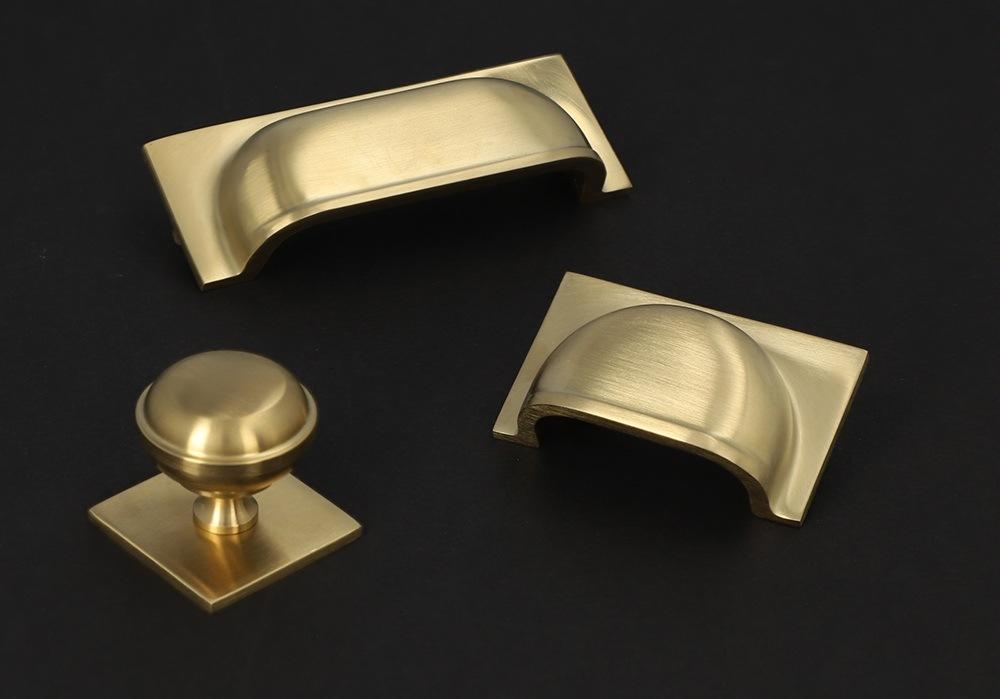 Satin Brass Cupboard Handles and Knobs by Alexander and Wilks at More Handles
