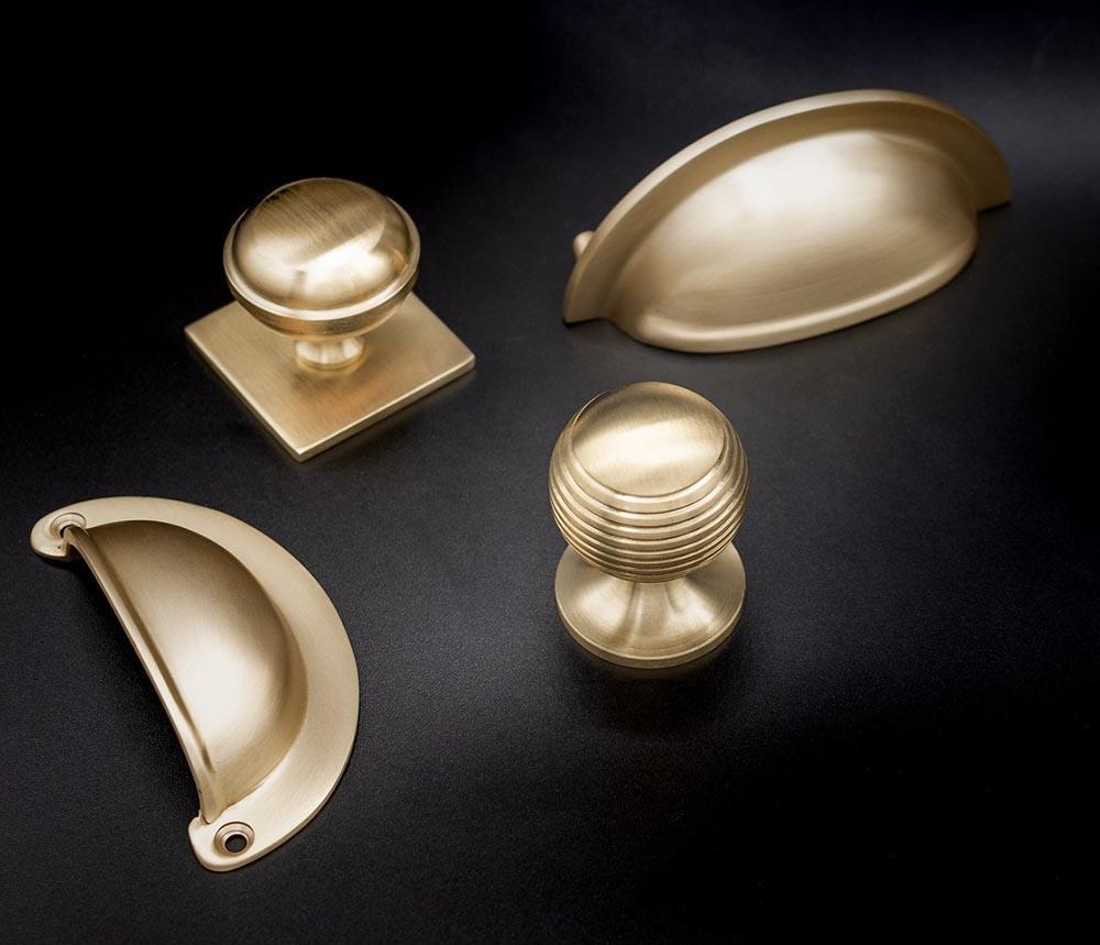 Satin Brass Cupboard Knobs and Cup Handles by Alexander and Wilks at More Handles