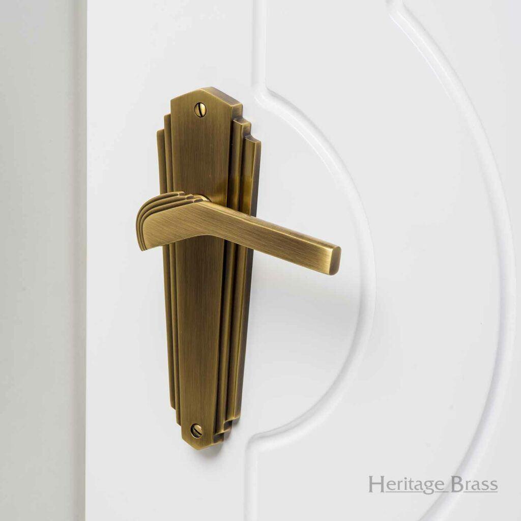 M. Marcus Heritage Brass Waldorf Art Deco Door Handle on white Door