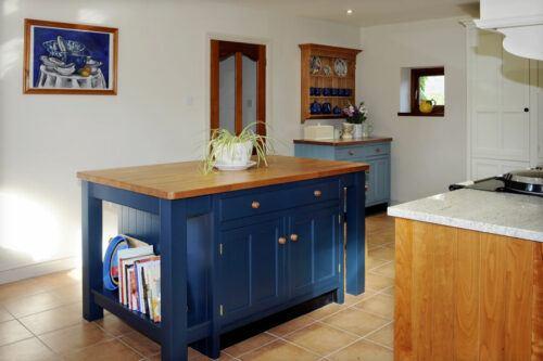Traditional wooden cupboard knobs on a blue kitchen island