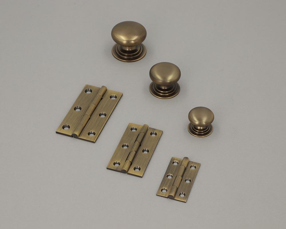 Alexander and Wilks Antique Brass Cupboard knobs and matching hinges.